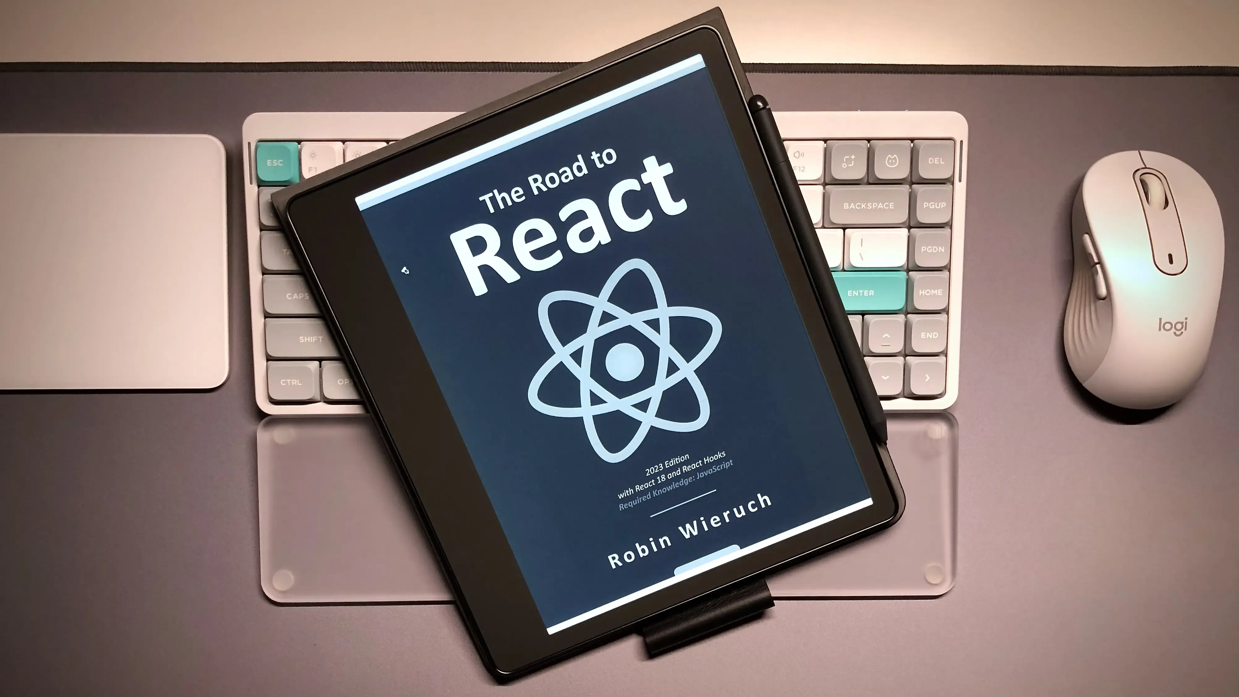 Post cover: The image shows an e-reader displaying the cover of the book &quot;The Road to React&quot; by Robin Wieruch.
